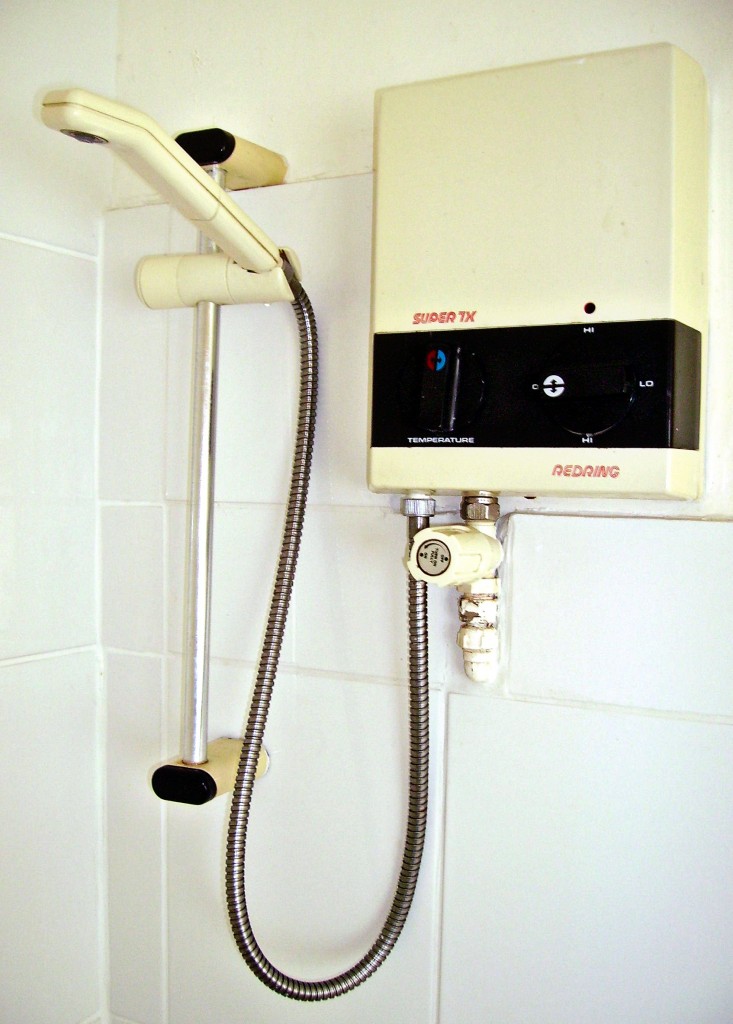 Figure 1. A point of use tankless water heater installed next to a shower. Credit: Immanuel Giel, Wikimedia.
