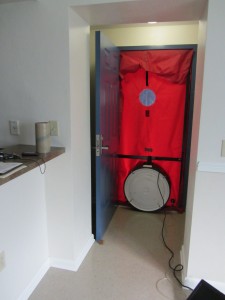 A blower door test set-up on a new home as it appears from the inside of the building. Credit: PREC