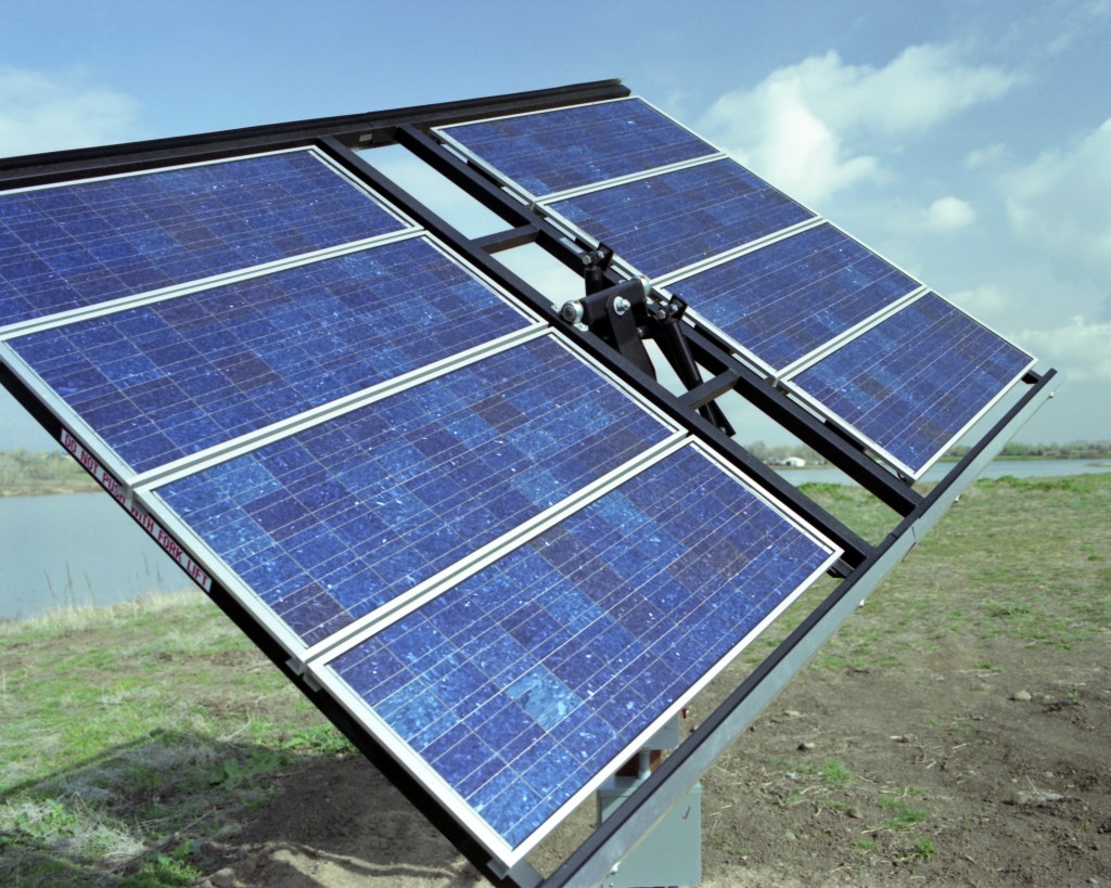 Figure 1. A sun-tracking, free-standing, solar PV array consisting of eight total PV panels, each constructed of 44 individual square polycrystalline PV cells. Credit: Warren Gretz / NREL.