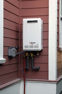 Figure 4. A whole-house tankless natural gas water heater installed outdoors showing its more simple venting system. Credit: Flickr user "omiksemaj" (CC BY-NC 2.0).