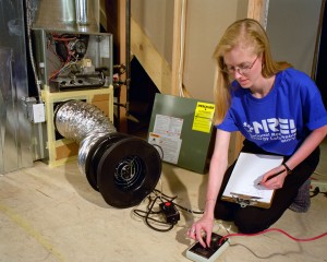  Figure 1. National Renewable Energy Laboratory staff member Sara Farrar conducts a duct blaster test to evaluate the duct leakage rate. (Credit: Warren Gretz / NREL 04913)